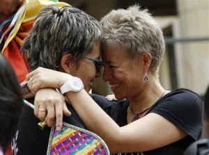 LGBT rights activists Sandra Rojas, left, and Adriana Gonzalez celebrate a Constitutional Court decision to give gay couples marriage rights, in front of the Justice Palace in Bogota, Colombia, Thursday, April 7, 2016. Gay couples in Colombia are already allowed to form civil unions, but the court ruling by a 6-3 vote expands rights further by giving gay couples marriage rights as well.  (AP Photo/Fernando Vergara)